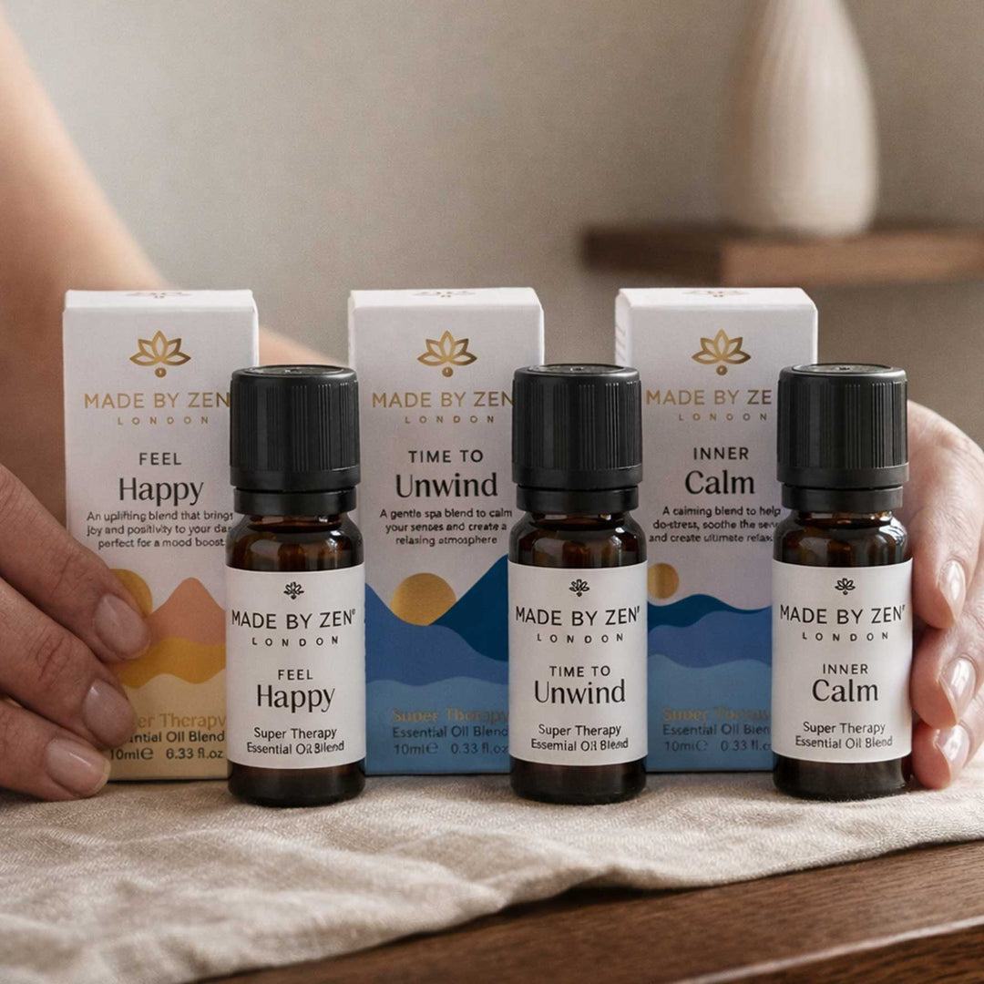 3 oil bottles with packaging in a line on a dark wood table